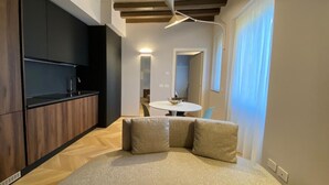 A modern living room with a sofa and a dining table. - One bedroom apartment- Bandello 22 (Milan)