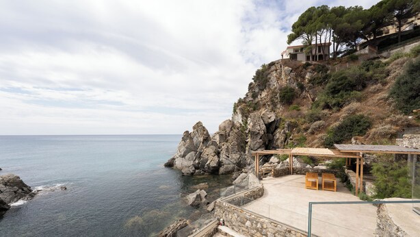 A coastal property with a stone staircase leading to a wooden deck overlooking the sea. - Blu70 (Staletti)