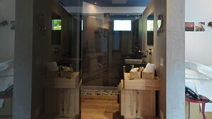 A modern bathroom with a glass shower enclosure, wooden vanity, and a large mirror. - Blu70 (Staletti)