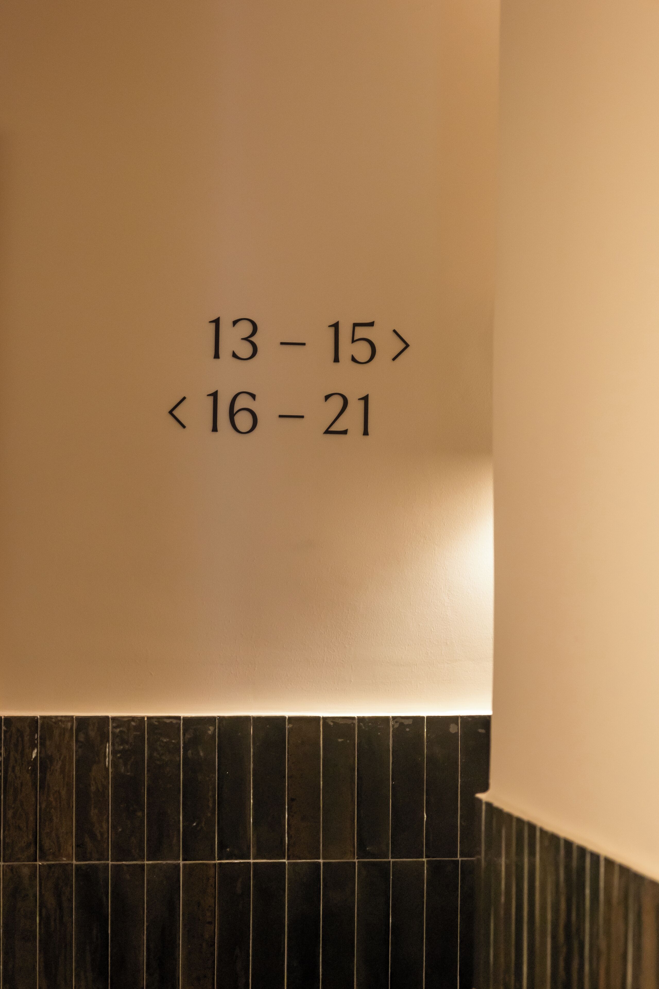 A wall with room numbers 13-15 and 16-21.
