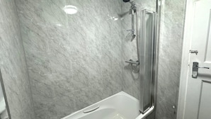 A bathroom with a bathtub, a shower, and a toilet.