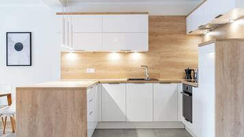 Apartment, Balcony, City View | Private kitchen | Fridge, oven, stovetop, dishwasher