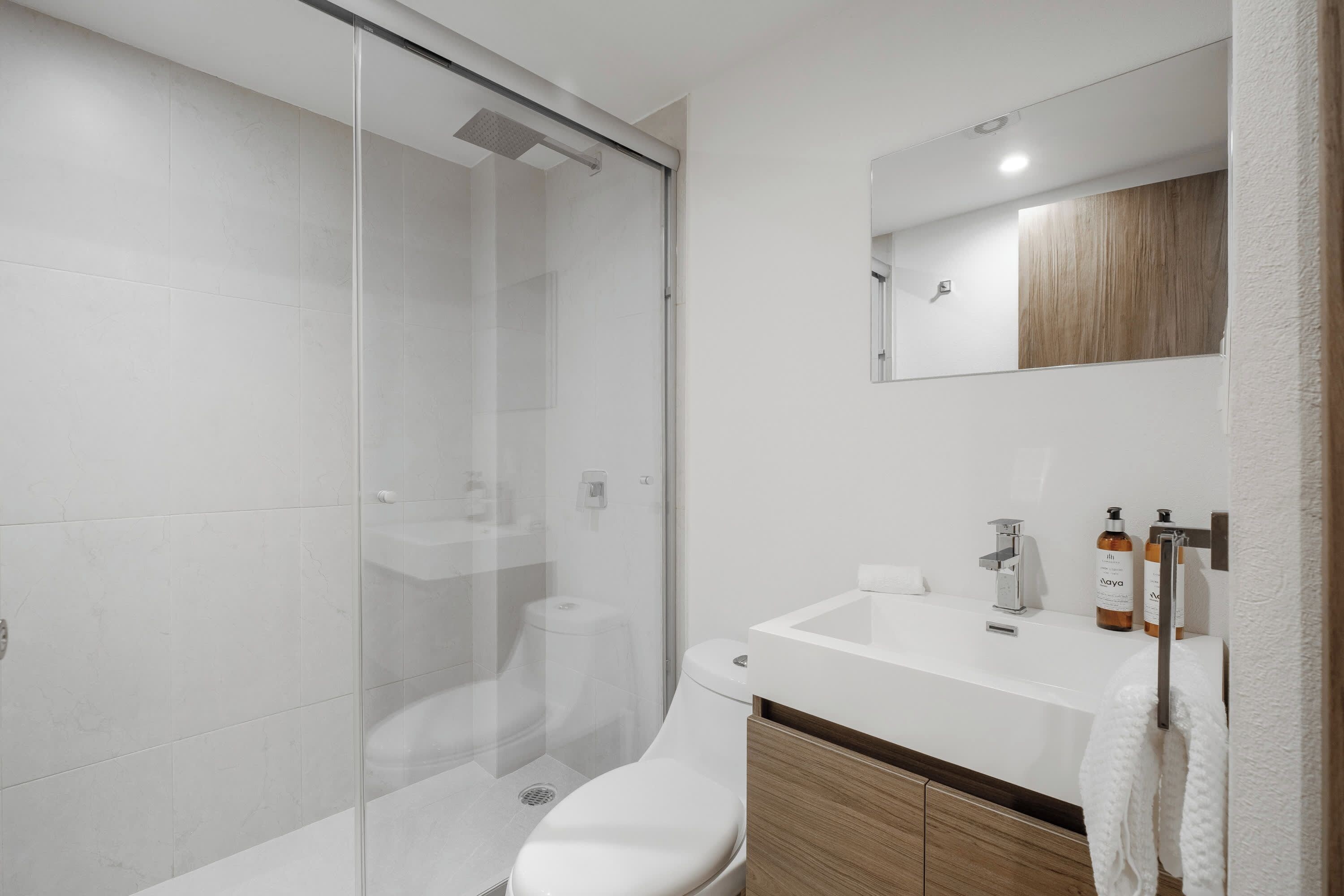 Fresh bathroom with a glass shower and sink, an easy place to rinse off and reset