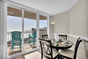 Enjoy meals on the balcony with a view of the water and surrounding buildings.
