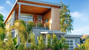 A modern two-story house with a balcony, large windows, and a wooden facade. - Surf Loft just blocks from Pleasure Point! (Pleasure Point)