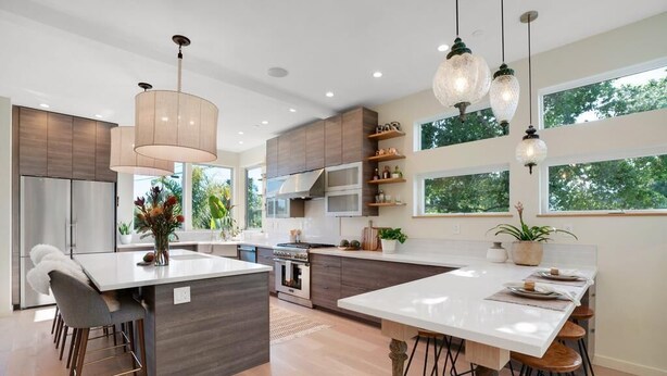 A modern kitchen with a central island, stainless steel appliances, and pendant lighting. - Surf Loft just blocks from Pleasure Point! (Pleasure Point)
