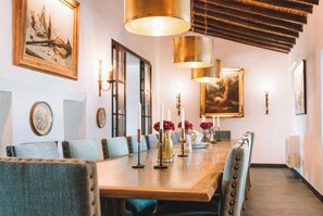 Enjoy meals in this elegant dining area with a long table and comfortable seating for six.