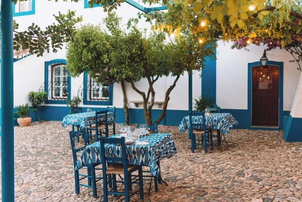 Enjoy dining al fresco amidst lush greenery and charming architecture.
