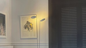 A modern living room with a green sofa, a small table, and a large window. - Superior Double Room (Avellino)