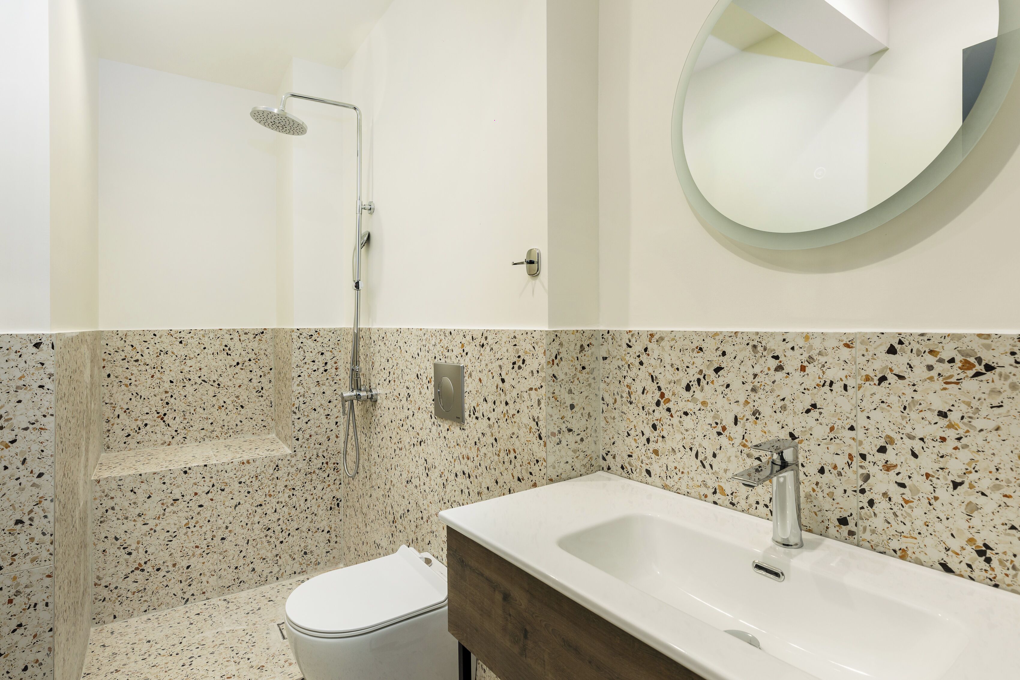 A bathroom with a shower, toilet, and sink.