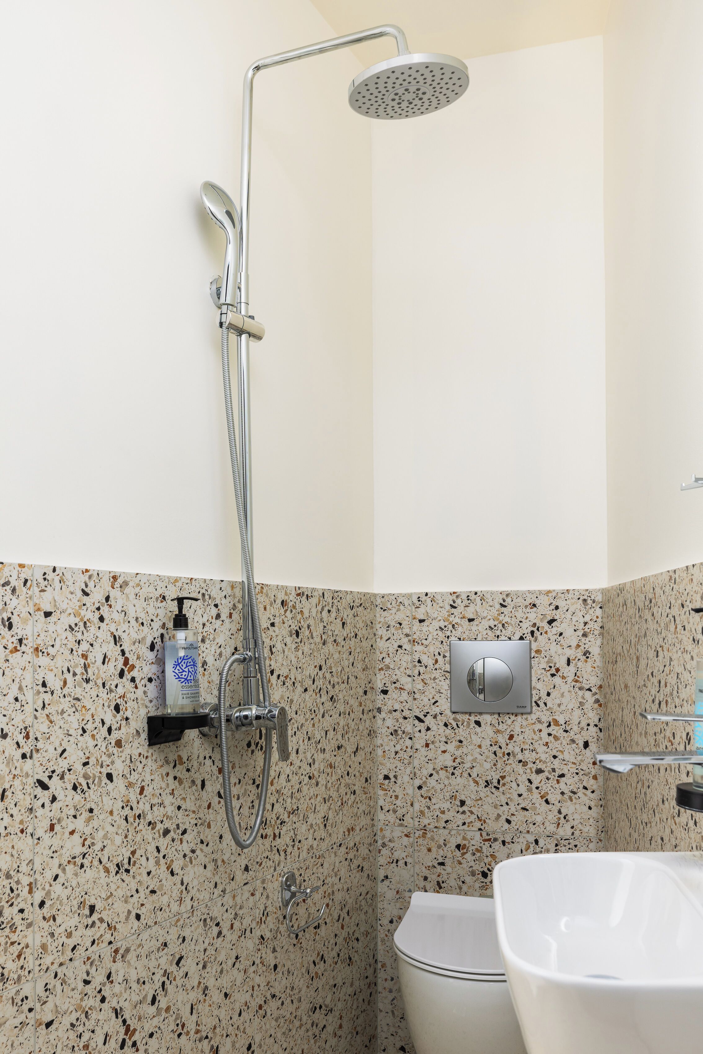 A bathroom with a shower, toilet, and sink.