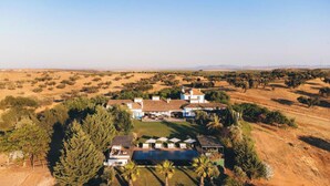 An aerial view of a property with multiple buildings, a swimming pool, and surrounding vegetation. - Rosemary Room (Póvoa de São Miguel)