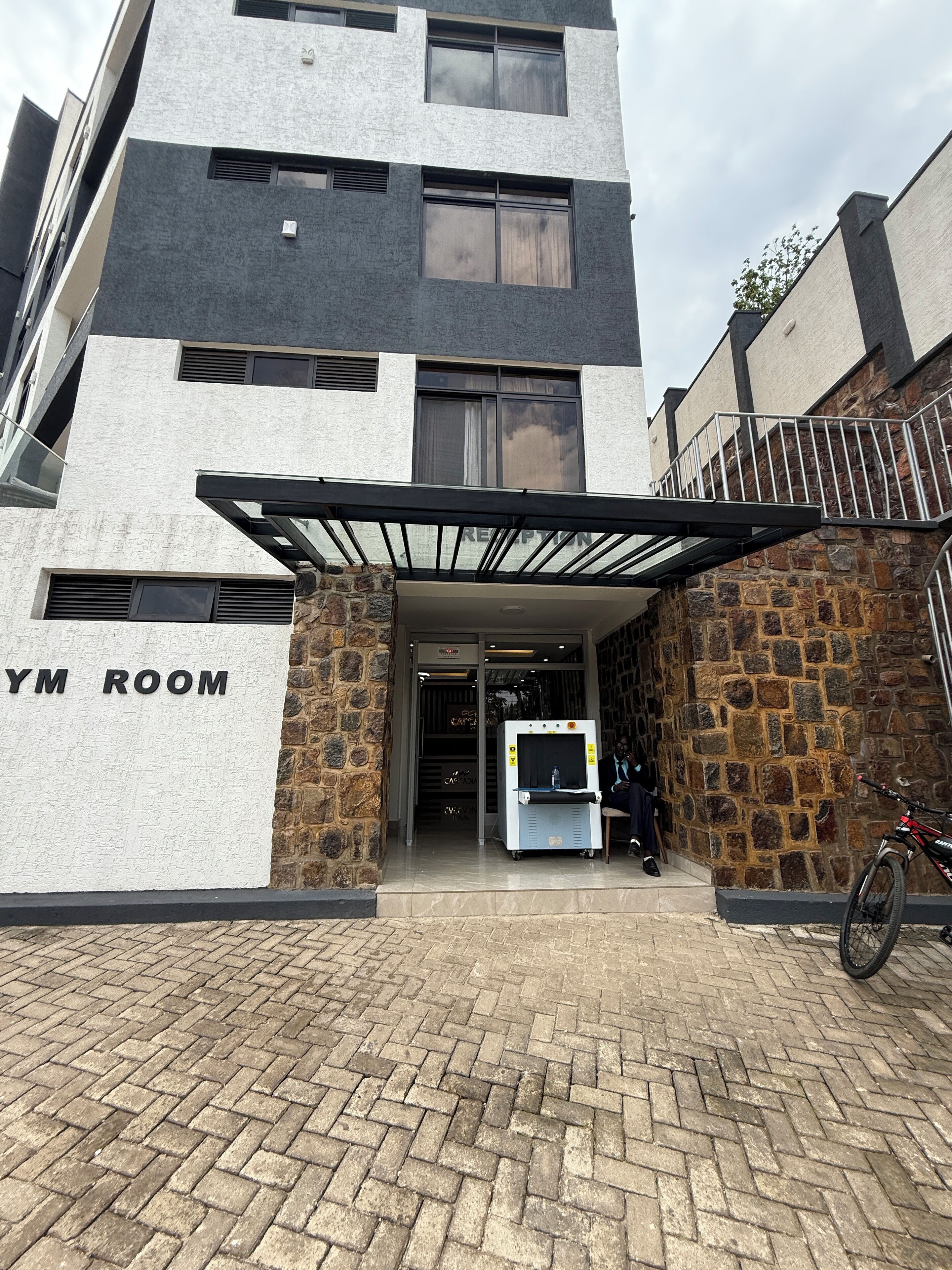 A building with a reception area and a sign indicating a gym room.