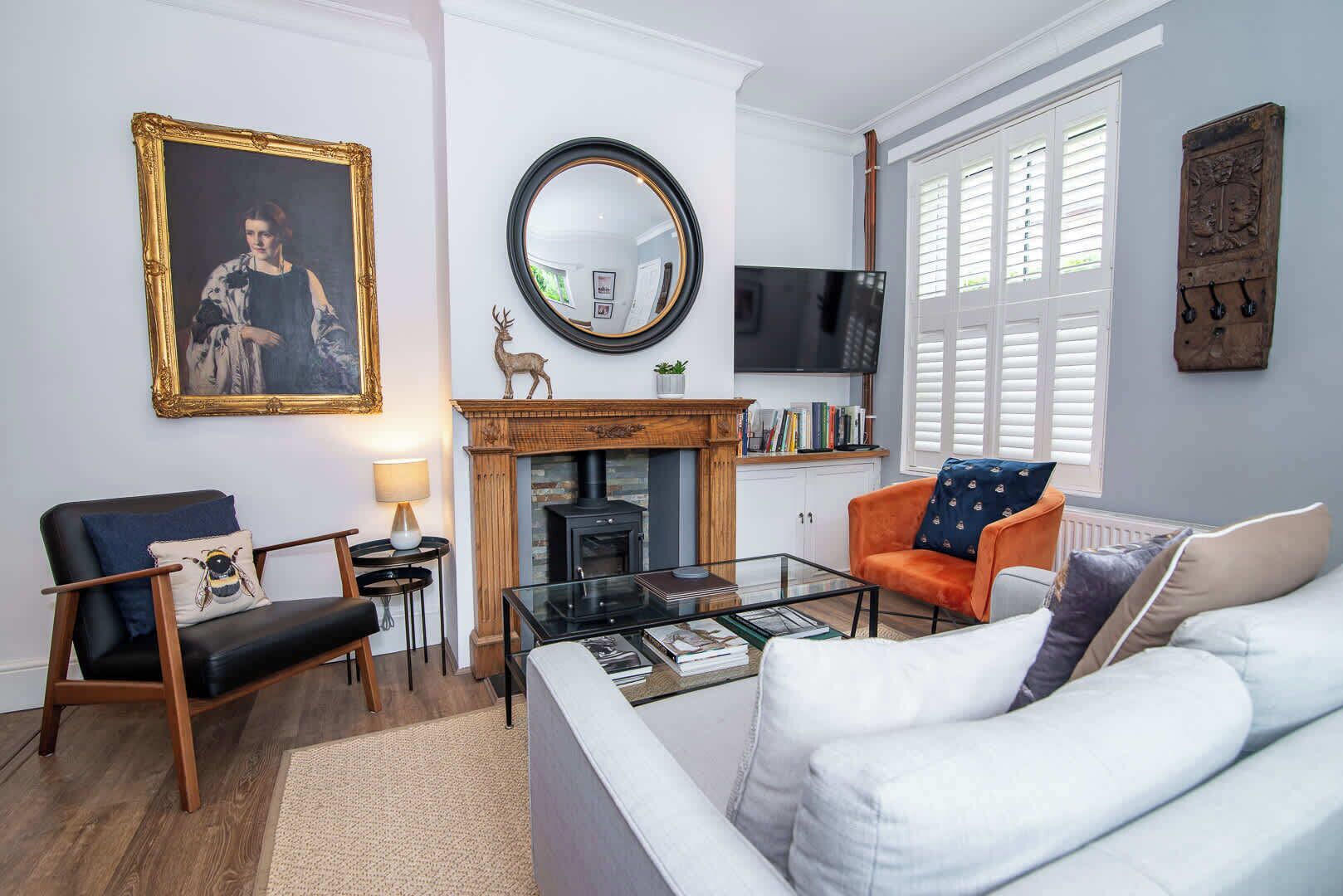 A living room with a fireplace, a television, and a sofa.