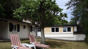 A house with a front porch and two lawn chairs. - Private cottage with it's own fishing & pet friendly! (Civray)