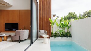 A modern outdoor living area with a pool, wooden panel walls, and comfortable seating. - SOLAIR Pererenan Loft #9 - 1 bdr - with pool and rooftop barbeque (Badung)