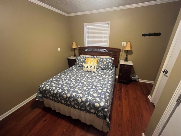 A bedroom with a bed, two nightstands, a window with blinds, and a door. - Boat parking, Trail to Lake, 3 minutes from boat ramp (Kingston)