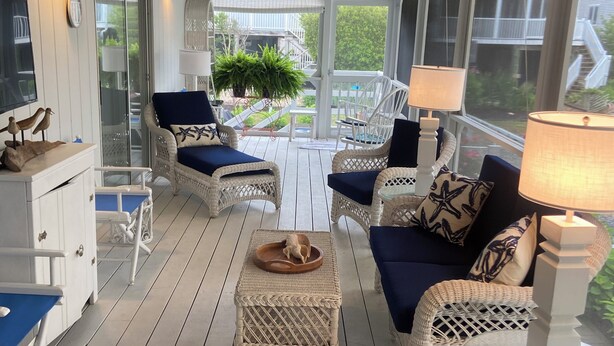 A covered porch with wicker furniture, a dining table, and a ceiling fan. - Town of Bethany Beach- one block from beach (Bethany Beach)