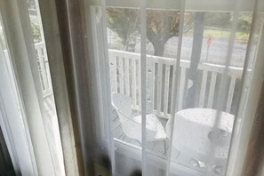 A view through a window with a white railing, a white chair, and a white structure. - Te Puia Hot Springs Hotel (Te Puia Springs)