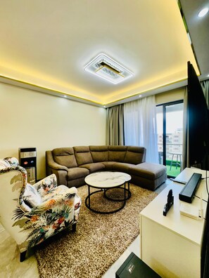 Business Apartment | Living area | 34-inch Smart TV with digital channels