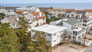 A coastal residential area with multiple two-story houses featuring balconies and ocean views. - Tower Shores Tiny Gem (Bethany Beach)