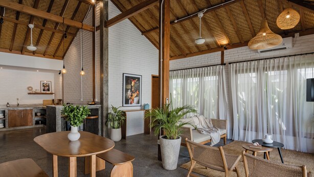 A spacious living area with a high ceiling, wooden beams, and a large window with sheer curtains. - Indah Sun Villa | Private Pool | 3BR | Pererenan, 2 Min to Cafés (Mengwi, Kabupaten Badung)