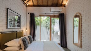 A bedroom with a bed, a headboard, a framed picture, and a window with curtains. - Indah Sun Villa | Private Pool | 3BR | Pererenan, 2 Min to Cafés (Mengwi, Kabupaten Badung)
