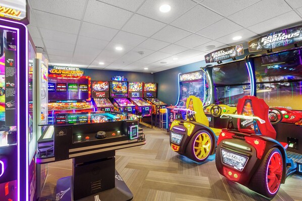 An arcade with multiple racing game machines, including a prominent 'Fast & Furious' themed car. - Grand Colorado 3BR | Ski-in/out Mountain Escape (Breckenridge)