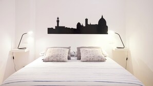 A hotel room with a bed, two bedside tables, and a wall-mounted cityscape silhouette. - "AL PALAZZO" - Pergola Suite - 500m from the Duomo (firenze)
