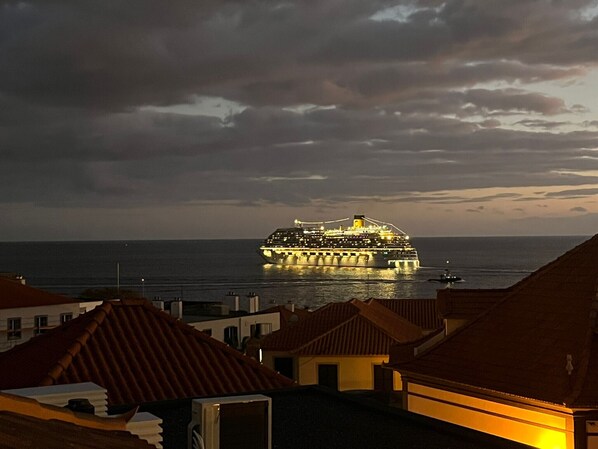 A large cruise ship docked at a port with a cityscape in the background. - FLH Funchal A Quinta do Conde Balcony Flat VI (Funchal)