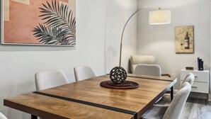 Een moderne eetruimte met een houten tafel, stoelen en een decoratieve bol in het midden.