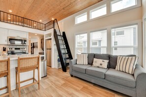 A modern kitchen with white cabinets, a stainless steel stove, and a wooden ceiling. - < 1 Mi to Marina: Lake Norman Home w/ Pool Access! (Sherrills Ford)
