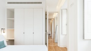 A bedroom with a bed, a wardrobe, and a hallway leading to another room. - Feel Porto Cl Rigos Charm Flat 3 1 (Porto)
