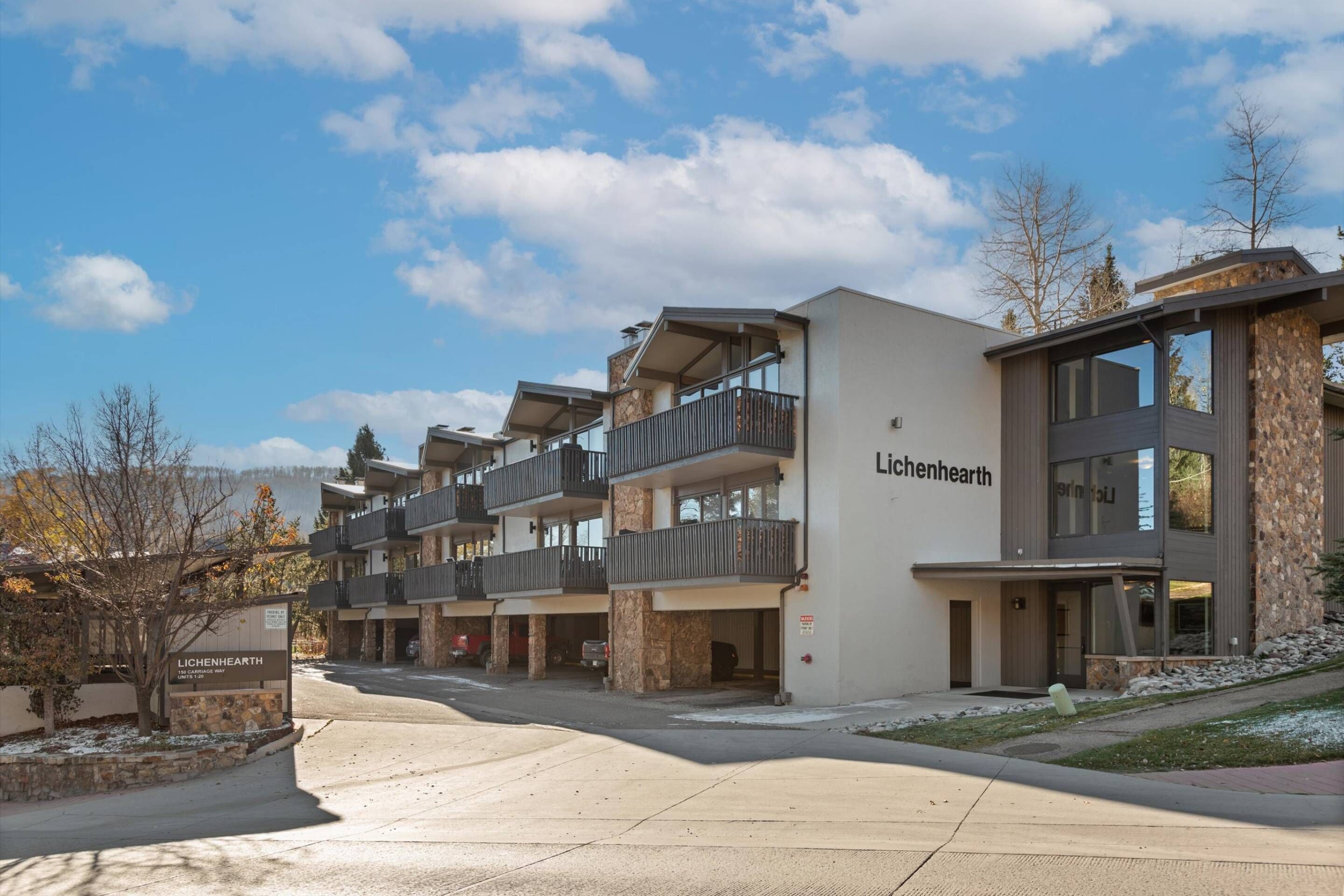 A modern multi-story building with balconies and a sign reading "Lichenhearth."