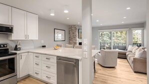 A modern kitchen with white cabinets, stainless steel appliances, and a central island.