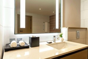 A modern bathroom with a large mirror, a sink, and a towel rack. - Hyatt House Nairobi Westlands (Nairobi)