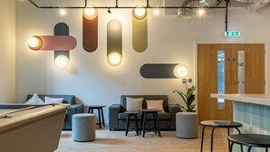 A modern lounge area with sofas, a pool table, and pendant lighting. - Student Only The Waterways (Nottingham)