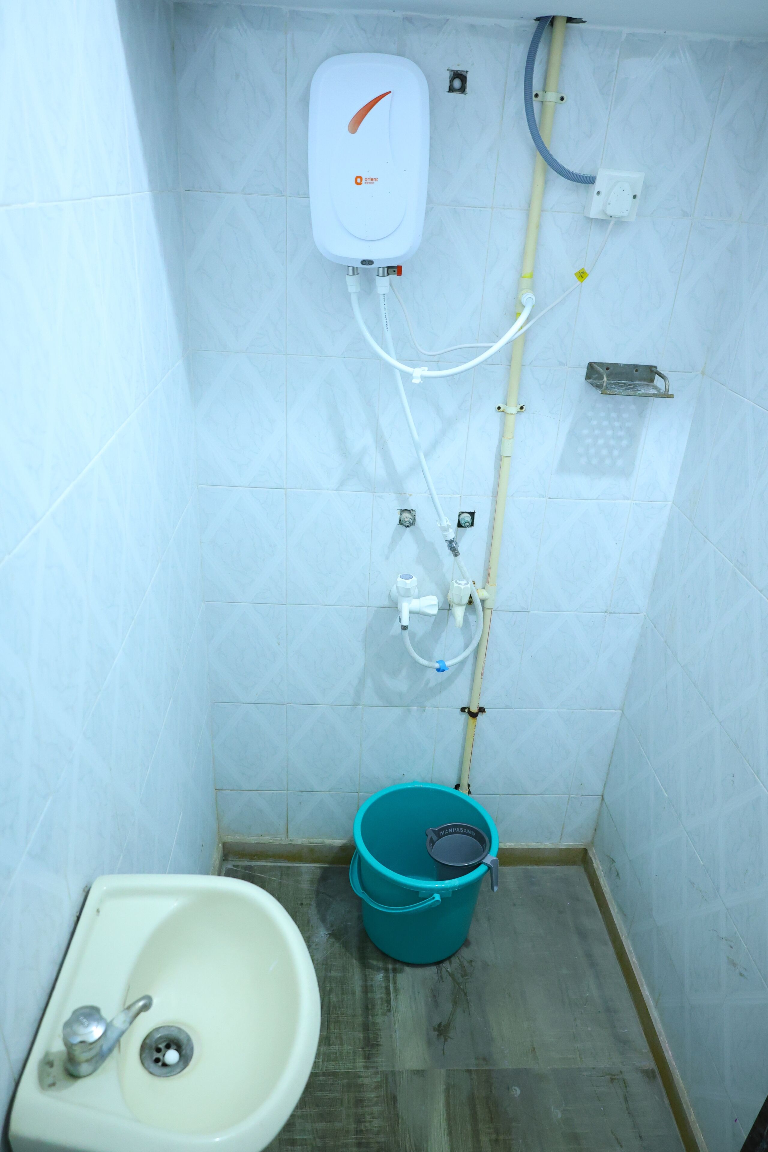 A bathroom with a white sink, a toilet, and a shower unit.