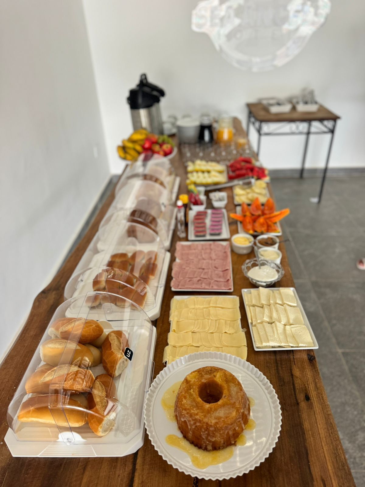 A buffet table with various food items including pastries, meats, and dips.