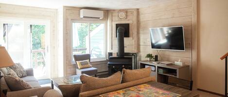 A cozy living room with a fireplace, a television, and a comfortable seating area.