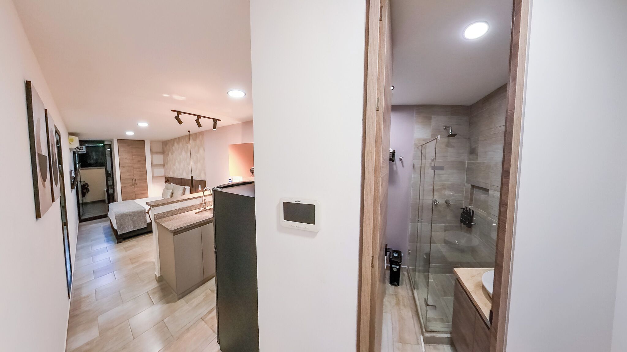 A modern bathroom with a glass-enclosed shower, a sink, and a toilet.