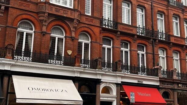 A multi-story red brick building with a white awning and a red canopy. - Charming Double Room in Central Mayfair /Unique stay/ Perfect location (London)