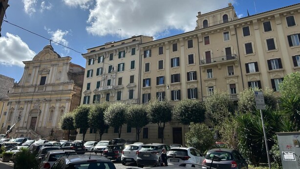 A multi-story building with a classical architectural style, featuring a prominent facade with columns and a central entrance.