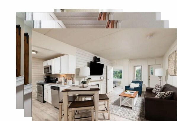 Cozy living space with a kitchen area, dining table, and comfortable sofa.