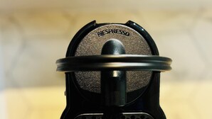 A Nespresso coffee machine with two coffee capsules on the base. - Mini - Small but cozy! (Brignoles)