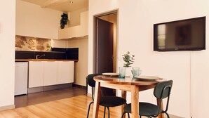 A modern kitchen with white cabinets, a black countertop, and a built-in oven. - Dubonnet - Coeur de ville (Brignoles)