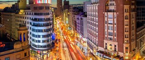 Experience the vibrant energy of a bustling city, where modern and traditional architecture blend in a lively downtown area.