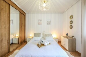 A neatly arranged bedroom with a large bed, bedside tables, a dresser, and a mirror. - A Relaxing Short Getaway 15` from Toledo (Cobisa)
