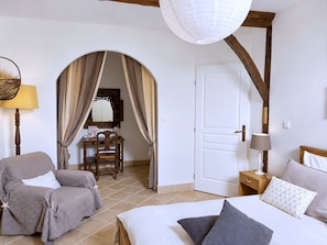 A bedroom with a bed, a chair, a desk, and a door. - Spacious 190 m² Holiday Home, Billiards, Memorable Gatherings near Canal du Midi (lagarde)