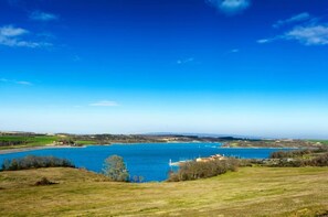 A lake with a clear sky, surrounded by grassy fields and distant hills. - Spacious 190 m² Holiday Home, Billiards, Memorable Gatherings near Canal du Midi (lagarde)